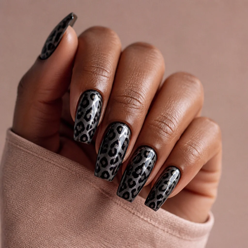 Coffin nails with a smoky mirror-chrome base and tonal black leopard print that shifts in the light