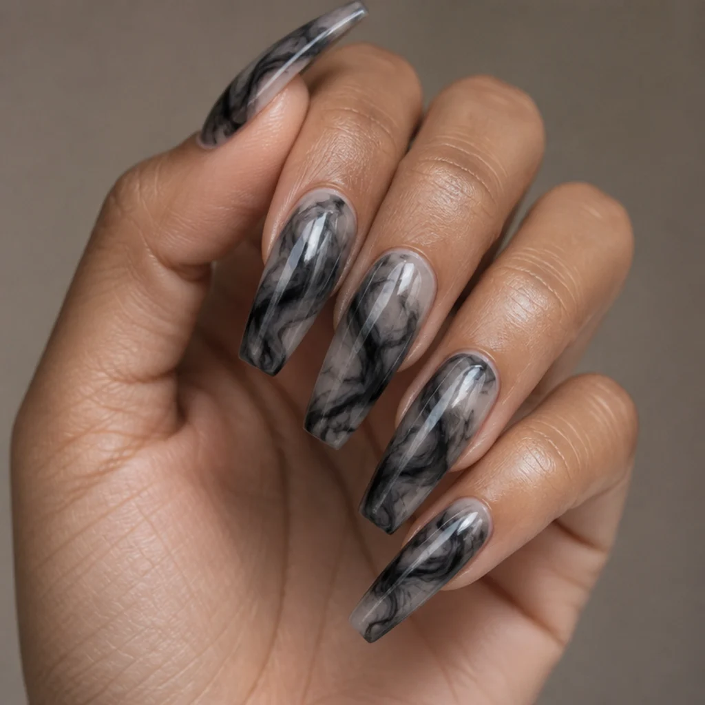 Long coffin nails with black and grey blooming gel marbled diffusion over a translucent base, no two nails matching, in a high-contrast editorial macro