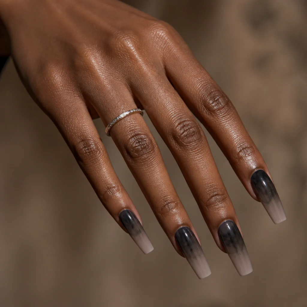 Long coffin nails wearing warm charcoal blooming gel diffusing from the cuticle into a smoky gradient