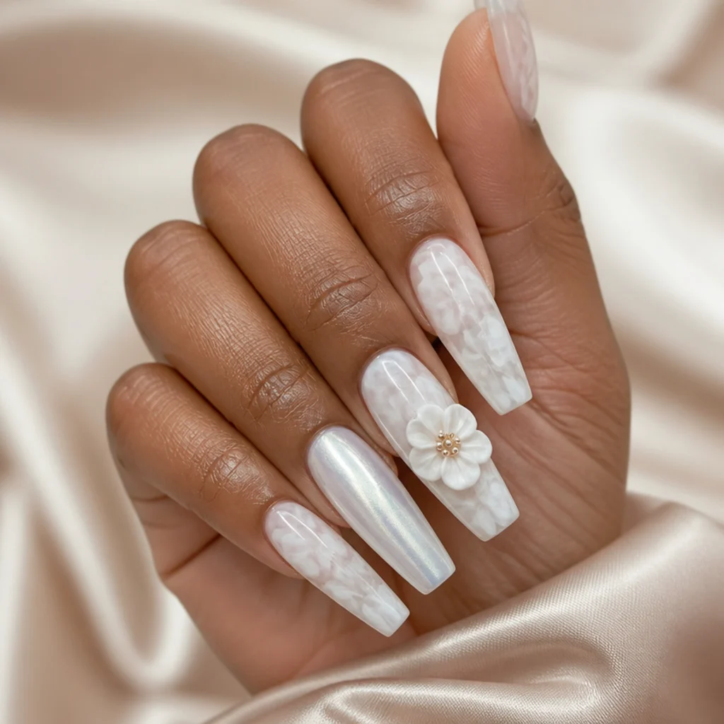 Long coffin nails combining a full watercolor bloom, frosted chrome accents, and one raised 3D flower for a bold finish, editorial macro