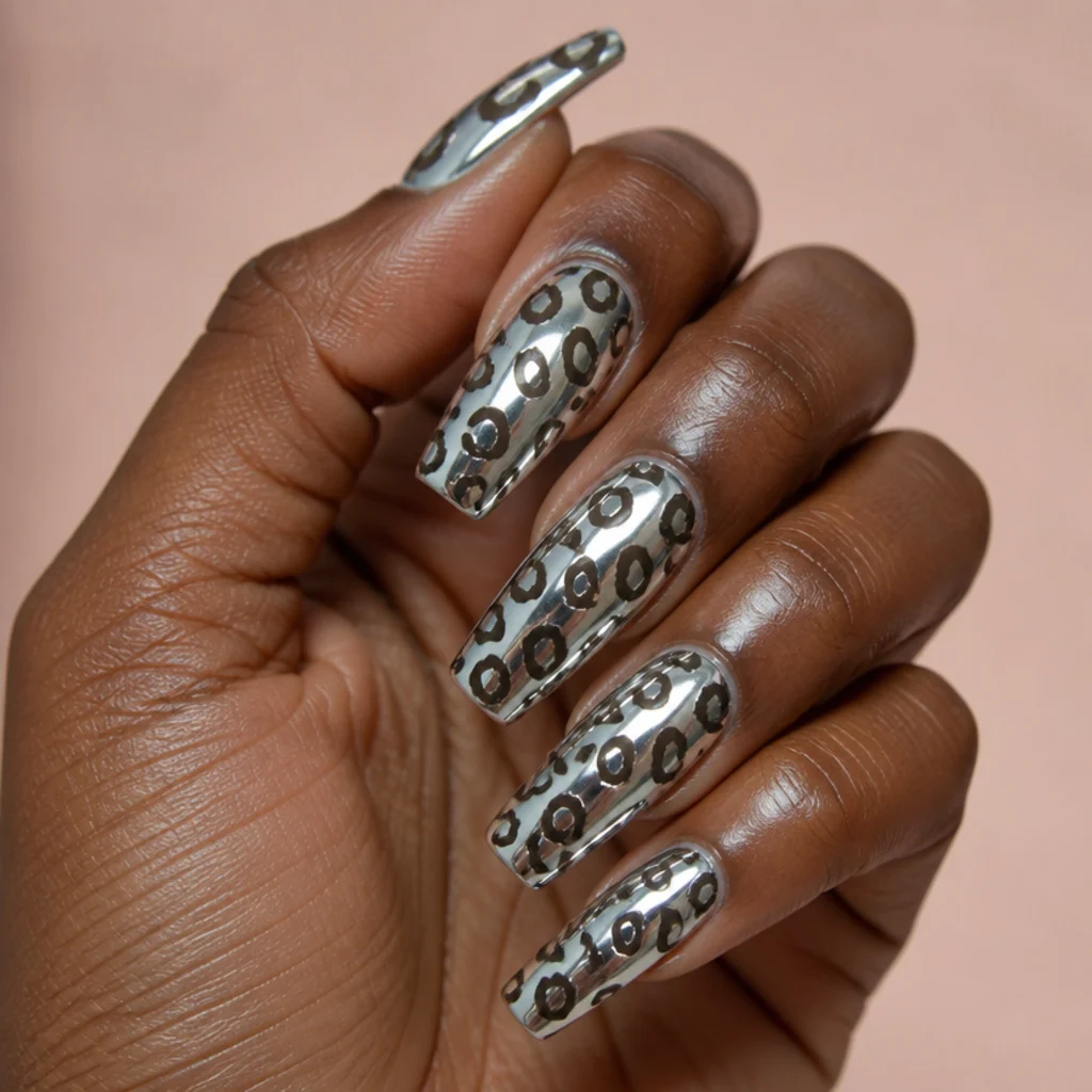 Long coffin acrylic nails in pearl chrome with black leopard spots and a mirror-like reflective sheen